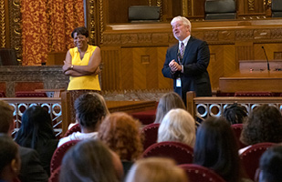 Image of Ohio Supreme Court Justice Melody J. Stewart and Justice Michael P. Donnelly speaking with a group of college students in the courtroom of the Thomas J. Moyer Ohio Judicial Center