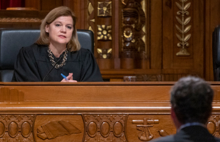 Image of a woman judge on the bench listening to a case