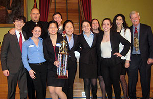 Image of students from Indian Hill High School posing with their first place trophy.
