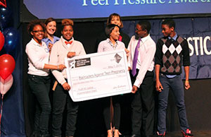 Image of a group of high school students holding an oversized check