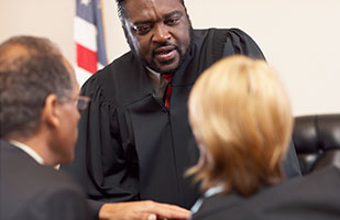 Image of a judge talking to two attorneys