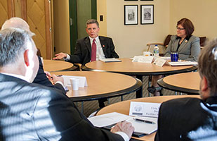 Image of Ohio Supreme Court Administrative Director Michael L. Buenger speaking with members of Supreme Court senior staff at a conference table