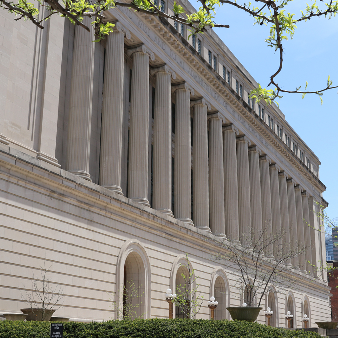 The exterior of Hamilton County Court house, a tall building with roman style pillars