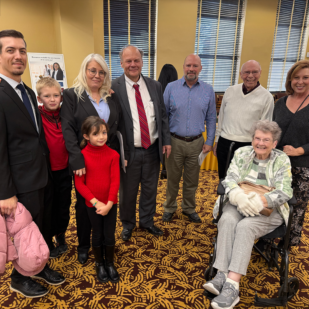 A family of nine smiling together