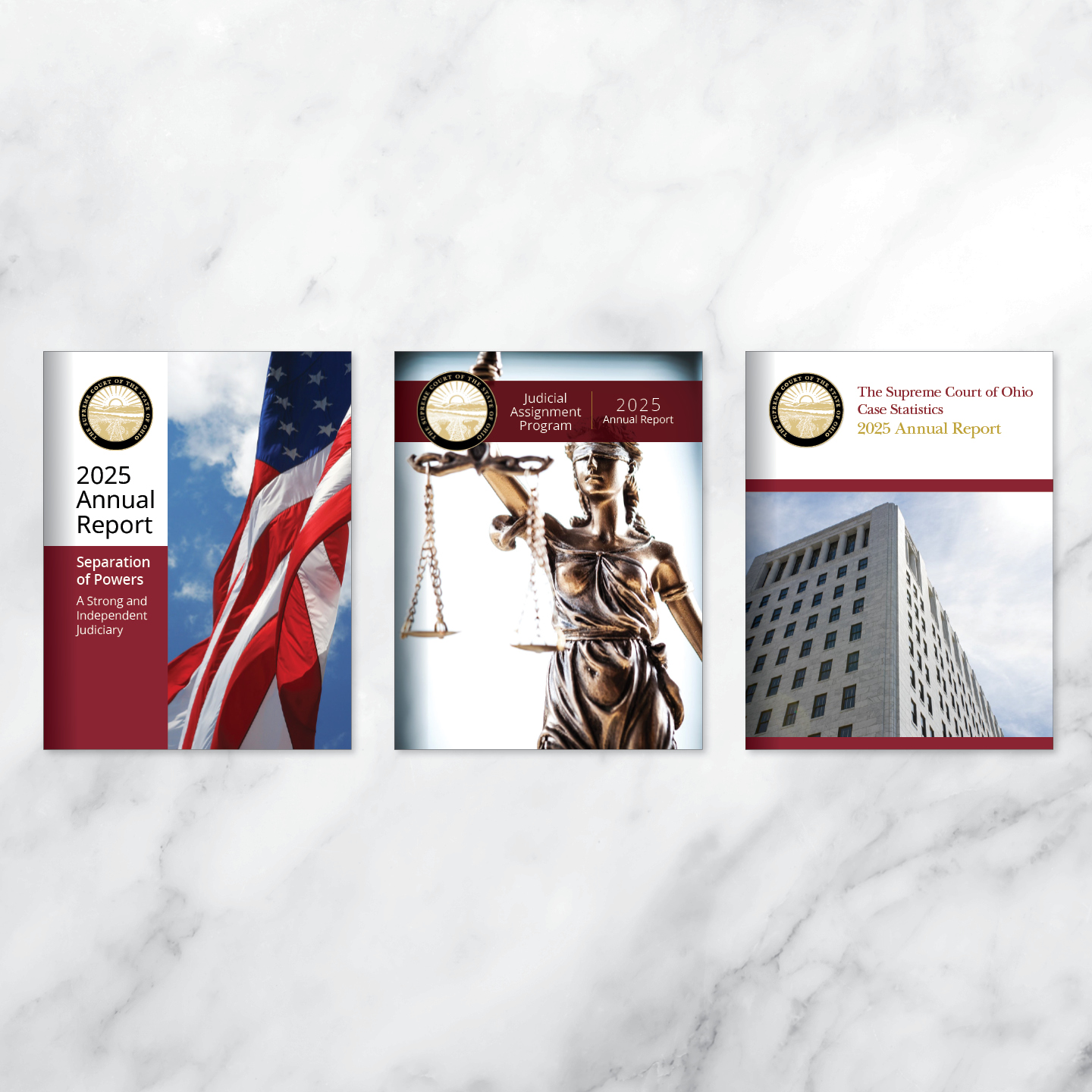 Three report covers are displayed against a marble background. The first shows a U.S. flag with '2025 Annual Report' text. The second features Lady Justice holding scales with similar text. The third depicts a courthouse under a cloudy sky, labeled 'The Supreme Court of Ohio 2025 Annual Report.'