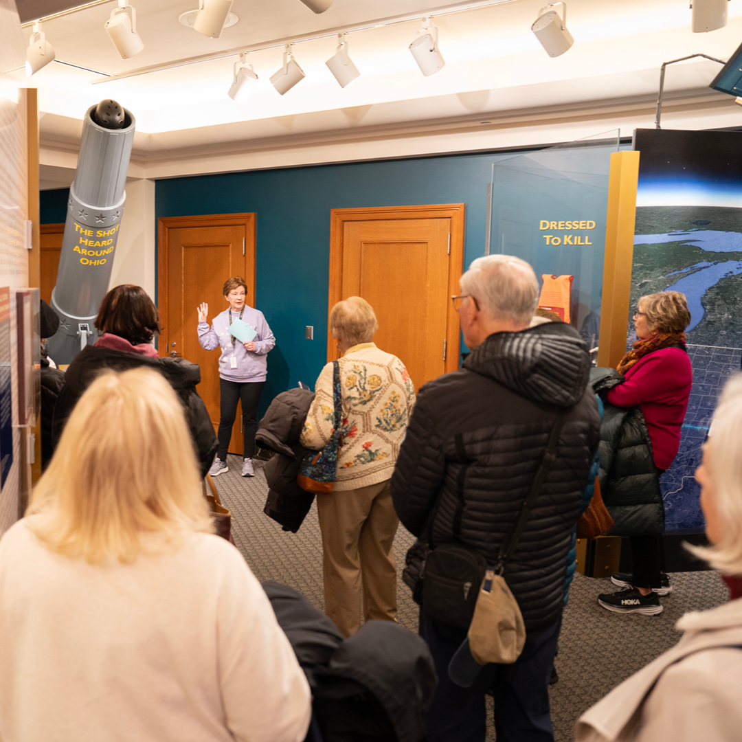 A man speaking at a podium to a large crowd