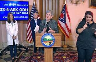 Image of Ohio Supreme Court Chief Justice Maureen O'Connor speaking from a podium while Ohio Gov. Mike DeWine and Ohio Department of Health Director Dr. Amy Acton stand in the background