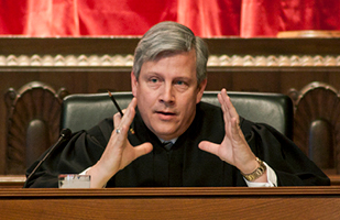 Image of a male judge participating in oral arguments