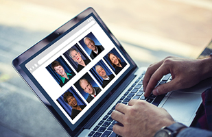 Image of hands on a laptop with the computer screen showing the pictures of the 7 justices of the Ohio Supreme Court