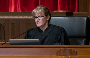 Image of Ninth District Judge Jennifer Hensal in her black judicial robe while sitting on the Supreme Court bench listening to case arguments