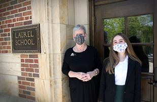 Image of Ohio Supreme Court Chief Justice Maureen O'Connor standing beside a Laurel School student in front of a school building