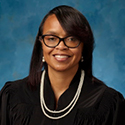 Image of a female judge wearing a black judicial robe