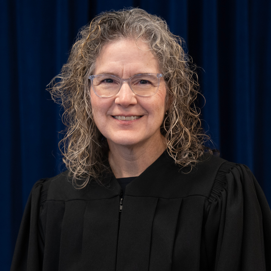 Female judge wearing a black judicial robe.