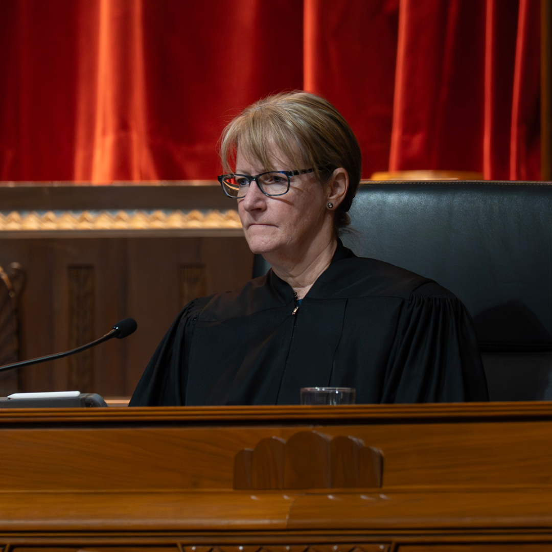 Female judge wearing a black judicial robe.