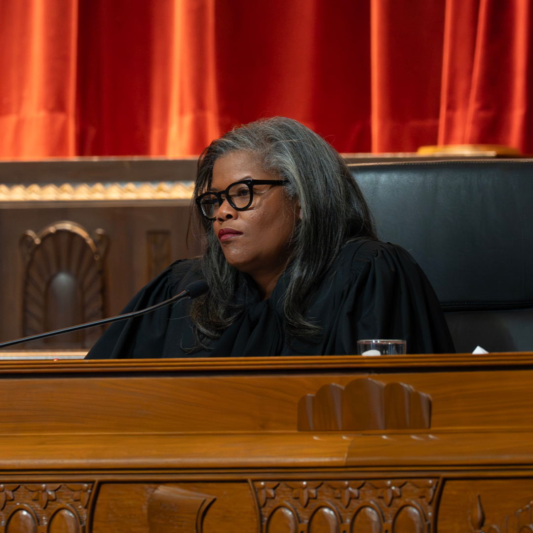 Female judge wearing a black judicial robe.