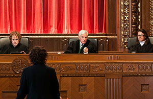 Image of Chief Justice Maureen O'Connor and justices Terrence O'Donnell and Sharon L. Kennedy listening to an attorney argue a case in the Ohio Supreme Court courtroom in the Thomas J. Moyer Ohio Judicial Center