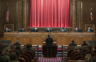 Image of an attorney presenting oral arguments before the Chief Justice and Justices of the Ohio Supreme Court in the courtroom of the Thomas J. Moyer Ohio Judicial Center