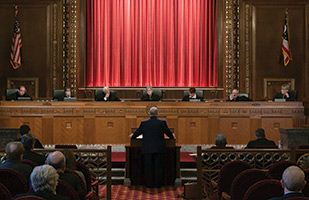 Image of an attorney presenting oral arguments to the Ohio Supreme Court Chief Justice and Justices in the courtroom of the Thomas J. Moyer Ohio Judicial Center