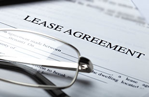 Image of a lease agreement under a pair of reading glasses
