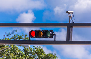 Image of a traffic signal with a camera mounted above it