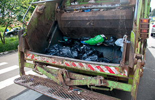 Image is of the back of a garbage truck