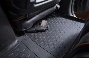 A handgun on a car seat.