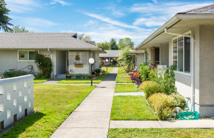 Image of a sidewalk running between a series of homes.