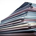 A stack of different pastel colored file folders.