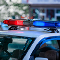 Image of the red and blue flashing lights on the roof of a police cruiser.