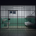 Image of a jail cell as seen from outside the cell.