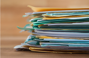 A stack of folders filled with documents.