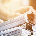 Multiple stacks of paper bound with large paper clips.