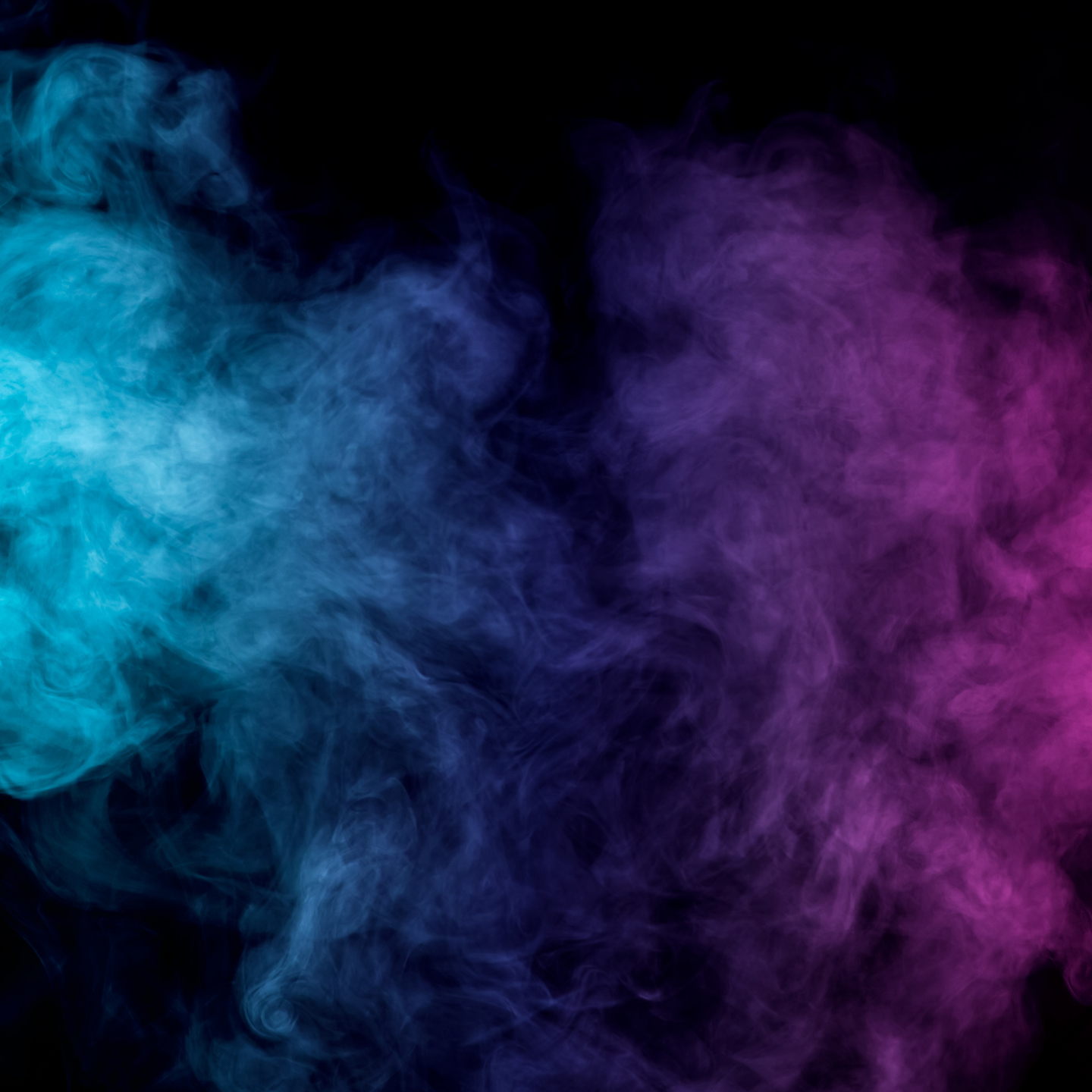 An abstract background featuring dense, wispy plumes of colored smoke swirling against a solid black backdrop, with vibrant cyan and light blue smoke on the left transitioning into deep purple and magenta smoke on the right.
