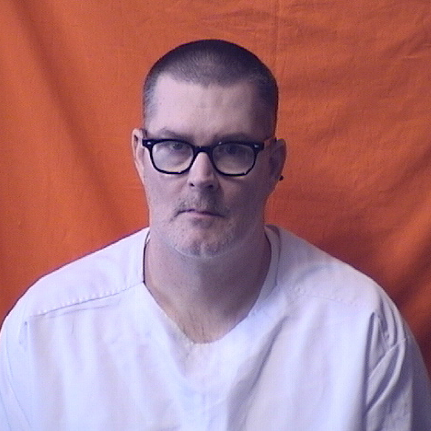 A man in a white shirt and glasses