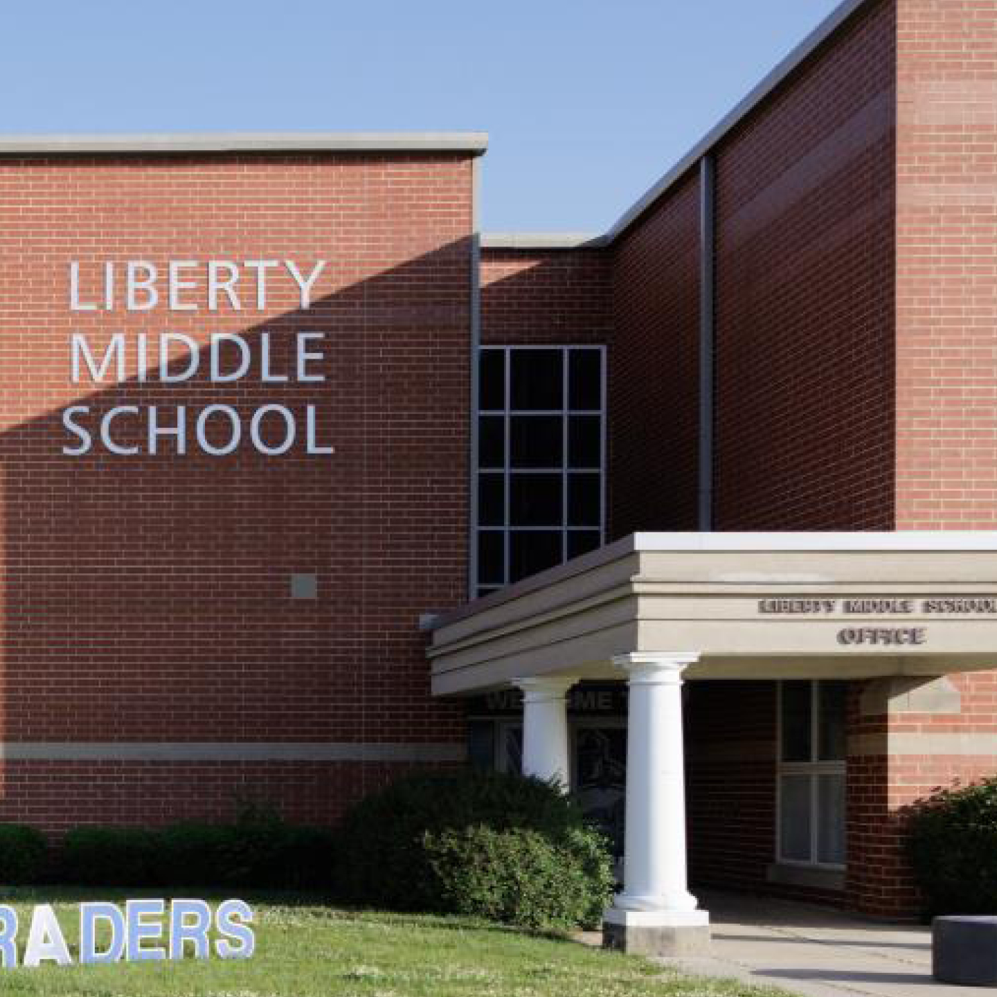 A red brick building with the words 'Liberty Middle School' on it