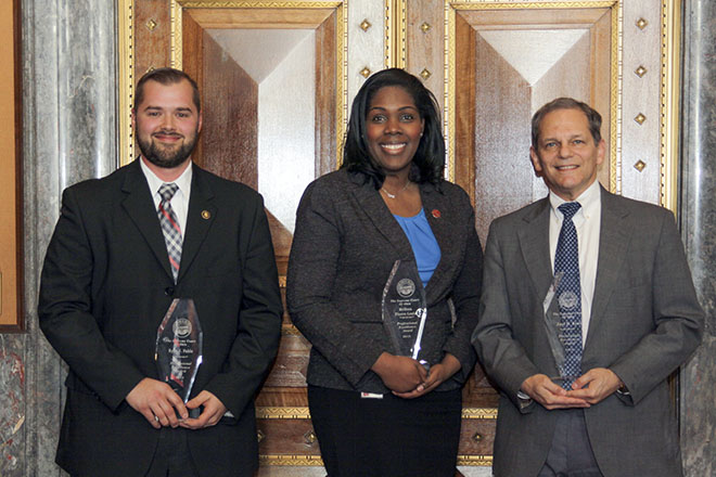 Image of three Ohio Supreme Court employees holding their Professional Excellence awards