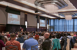 Image of a crowd of people listening to a speaker