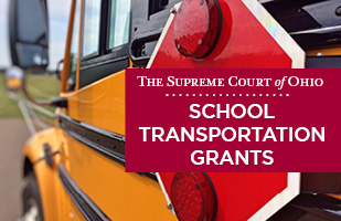 Image of the side of a yellow school bus with the words 'The Supreme Court of Ohio School Transportation Grants'