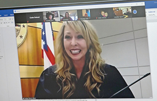 Image of a smiling woman in a black judge's robe