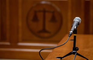 A courtroom table with a microphone