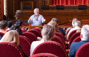 Man speaking to a tour of men and women in the Ohio Supreme Courtroom.