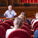 Man speaking to a tour of men and women in the Ohio Supreme Courtroom.