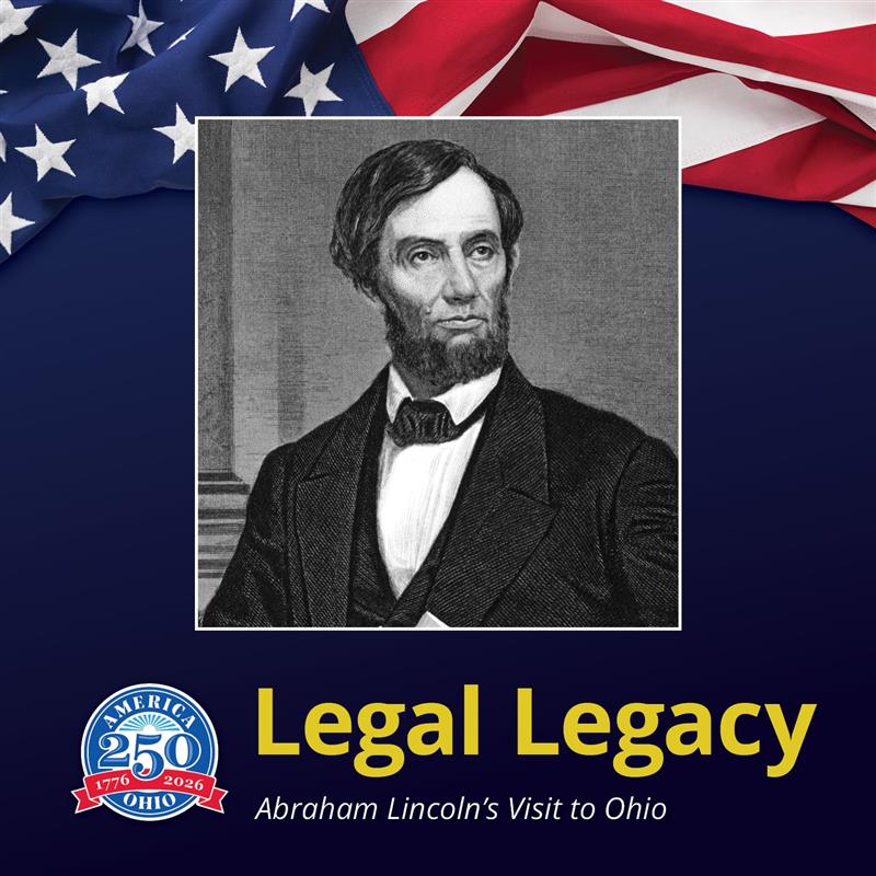 A man, Abraham Lincoln, holding a paper in one hand and resting his other elbow on a stack of books