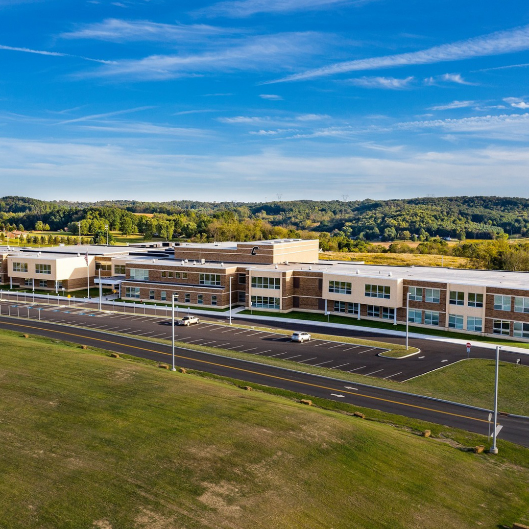 A school surrounded by hills and trees