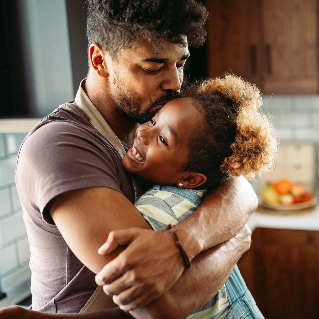 A father and a child hugging