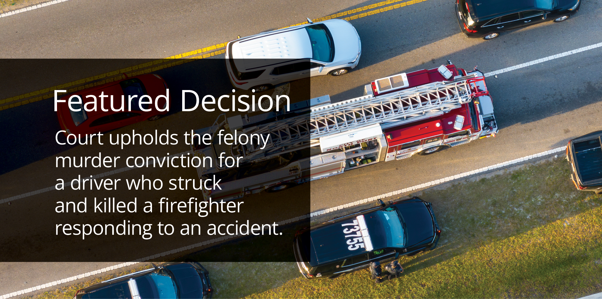 A ladder fire truck on a highway surrounded by cars