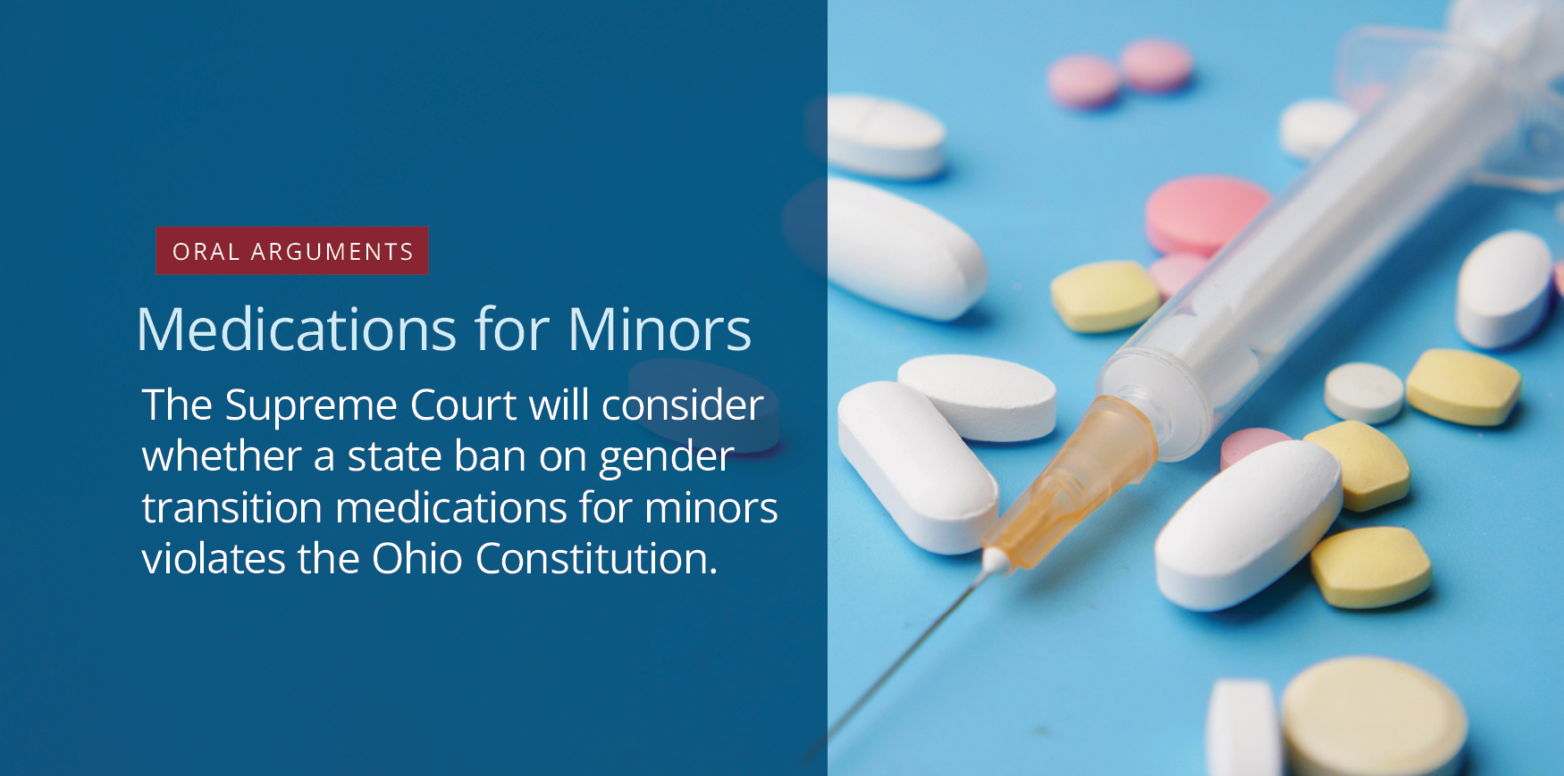 A syringe surrounded by pills of varying shapes, sizes, and colors