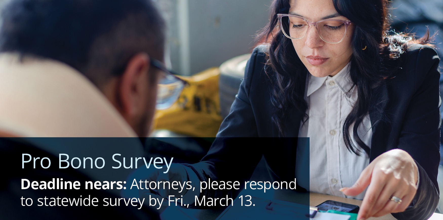 A woman and a man looking over documents on a desk with text reading 'Pro Bono Survey. Attorneys: Take part in a statewide effort to understand legal service needs.'