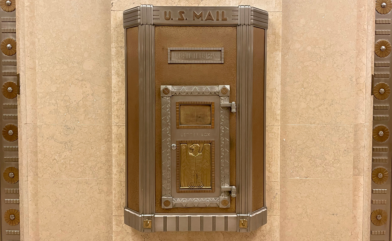 Image of an ornate, bronze mailbox