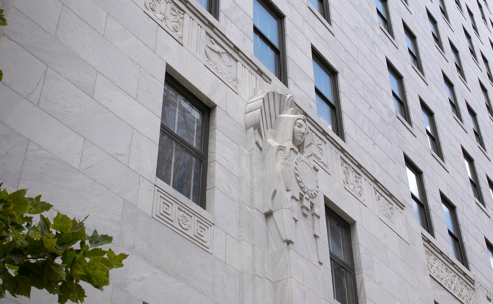 Image of a sculpture that appears to hold a sun carved on the south end of the Thomas J. Moyer Ohio Judicial Center
